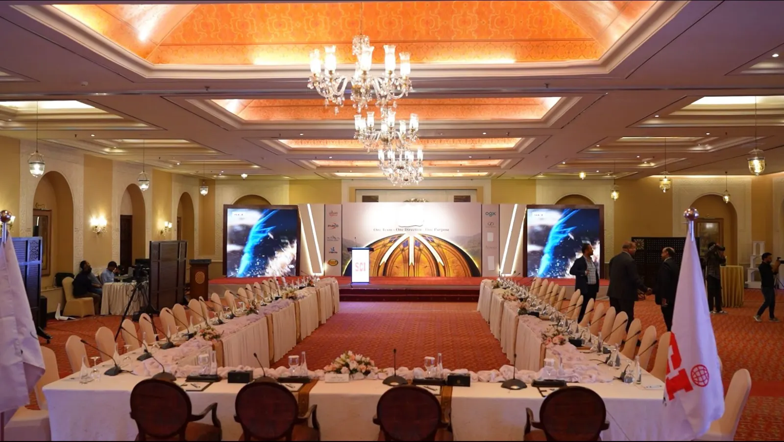The Serena Hotel ballroom set for the conference, with long tables facing a stage that reads One Team, One Direction, One Purpose.
