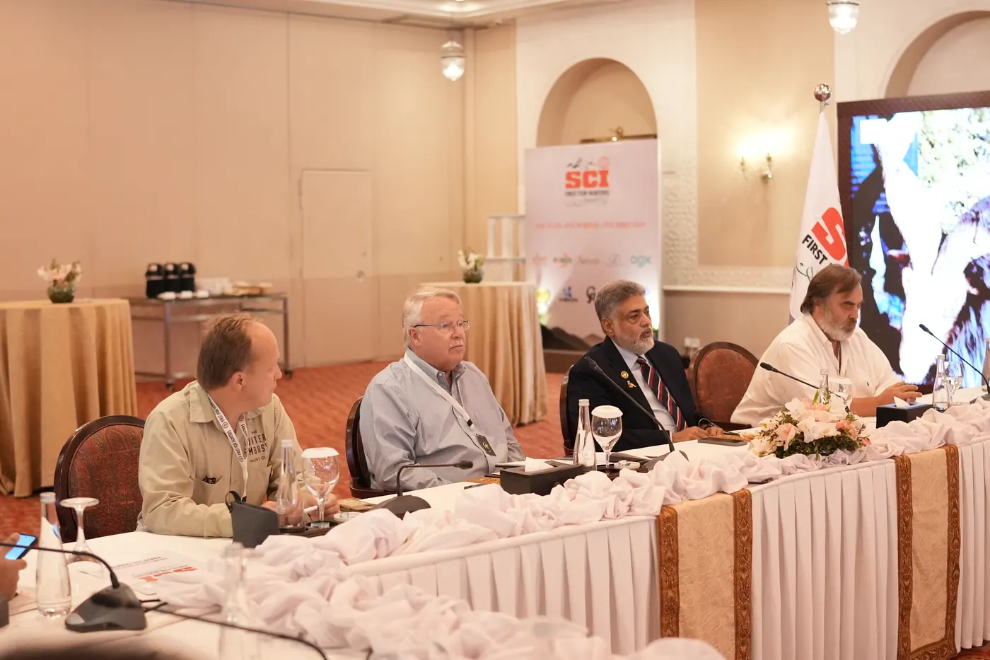 Panellists at the head table beside the SCI flag.