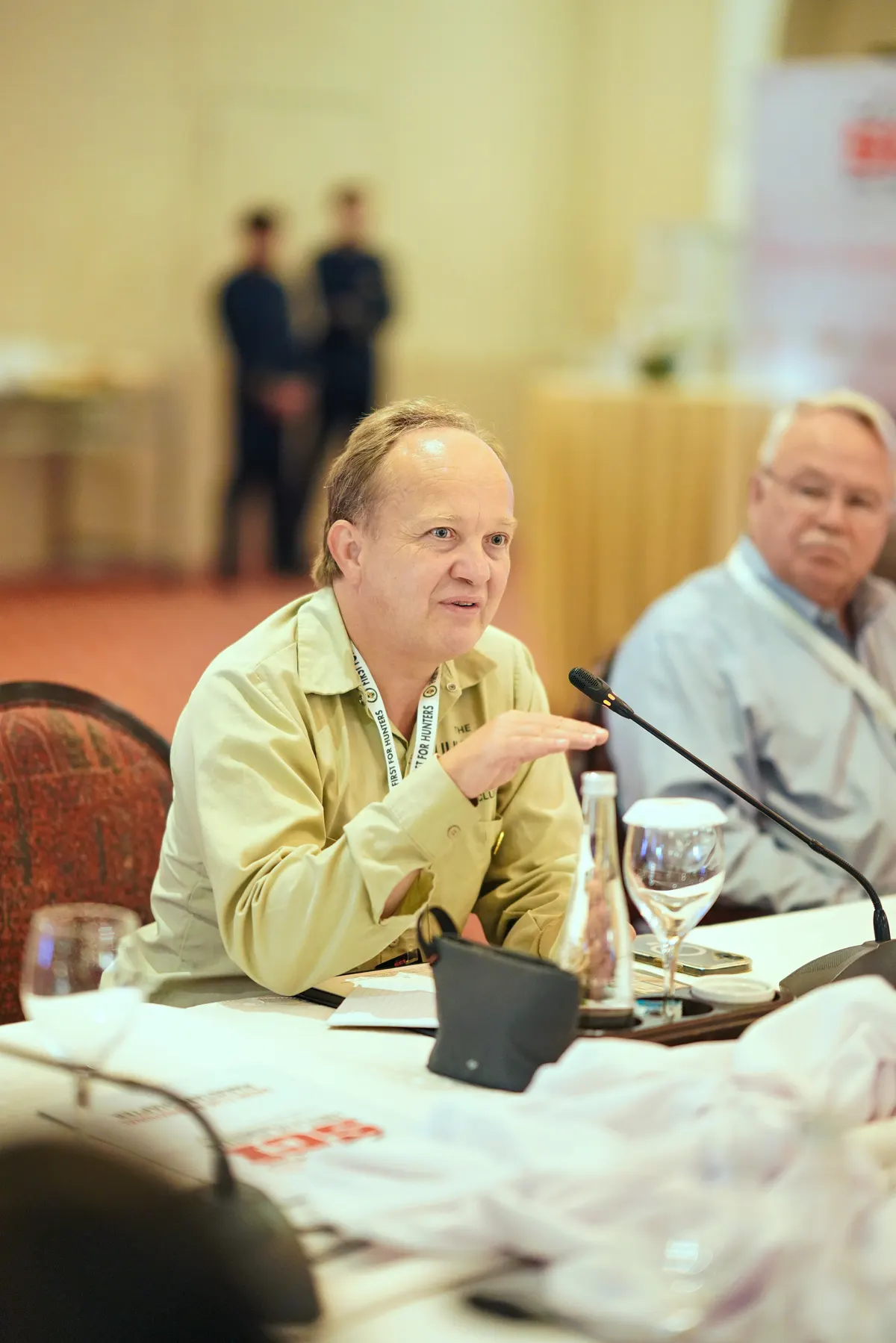 A delegate speaks into a microphone during the conservation roundtable.