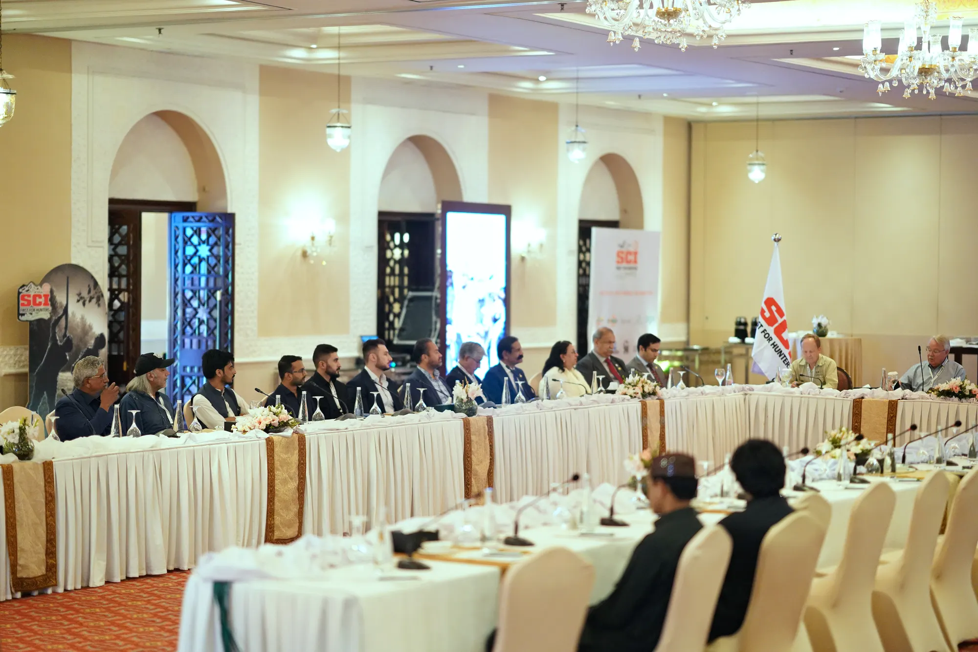 Delegates seated around a long conference table for the conservation roundtable.