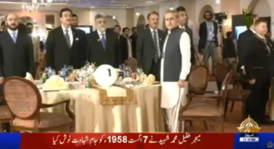 PTV News broadcast still of guests standing beside a dinner table at the gala.