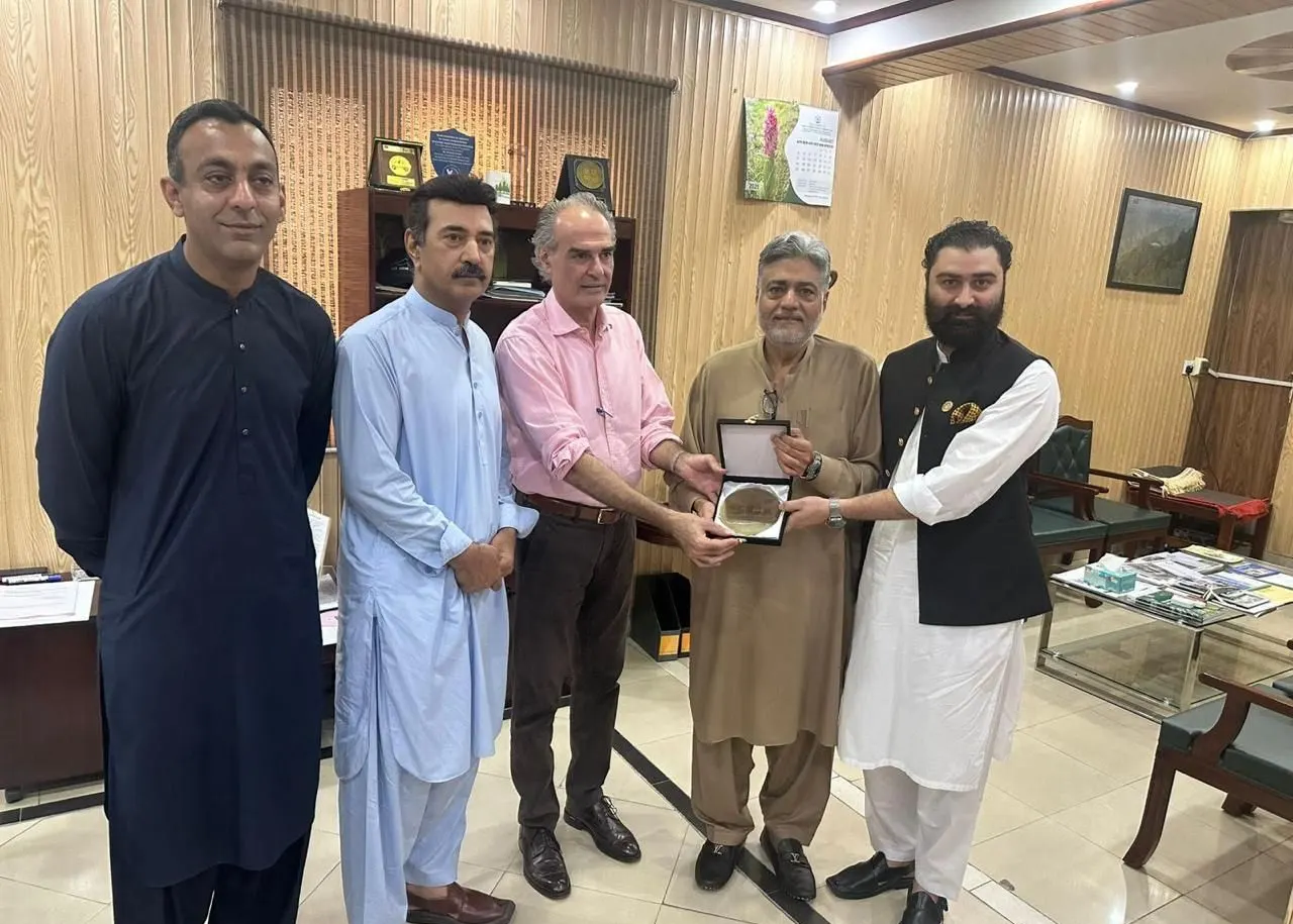 Chapter representatives present a shield to the Secretary, Wildlife and Forest, at a meeting in his office.